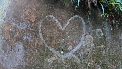 love heart carved into a rock wall by bend in road. iya valley, shikoku, japan