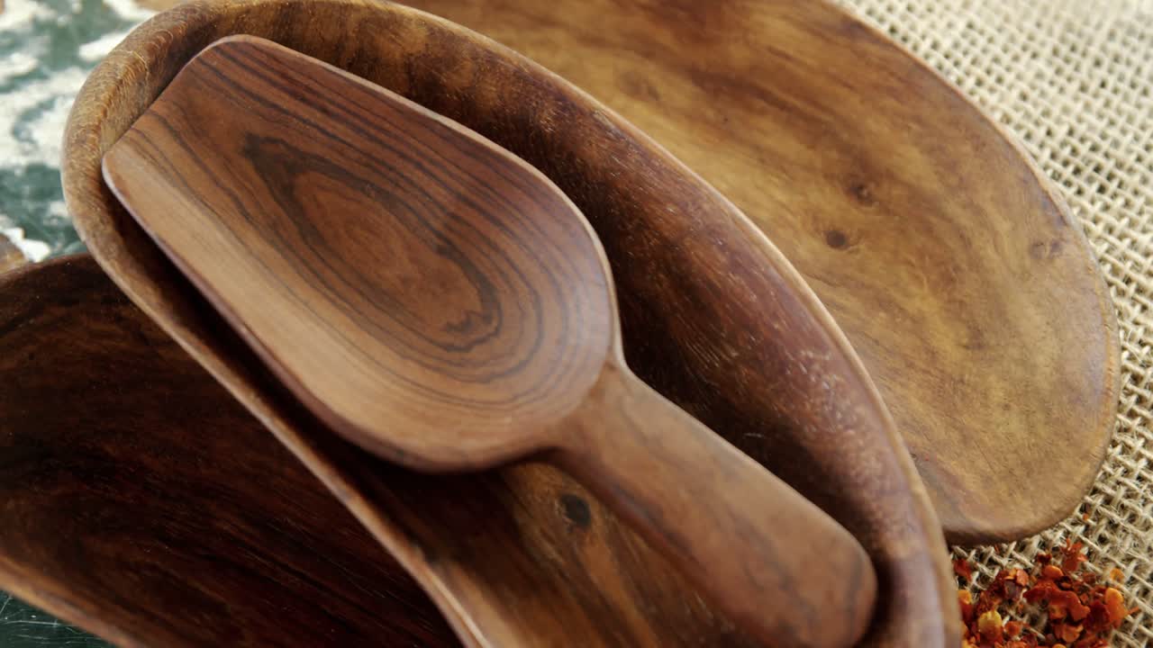 Empty wooden bowl with crushed red pepper on sack 4k