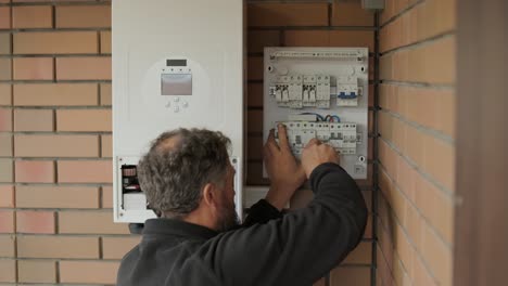 an electrician installing an inverter in a home. the image shows technical skill, modern tools, and attention to safety in electrical work