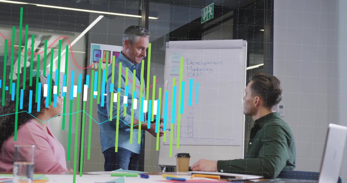 Mature speaker writing key topics then drawing chart overlaying red trend line for business review