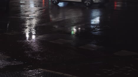 wet road with cars passing by night view