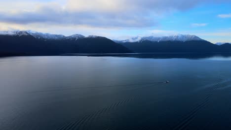 Aerial-view-truck-left-of-a-lone-boat-sailing-on-Lake-Todos-Los-Santos,-southern-Chile