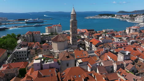 revealing shot of bell tower of cathedral of saint domnius in ancient split in croatia. aerial tilt-up