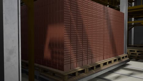 stacked red bricks on pallet in a factory