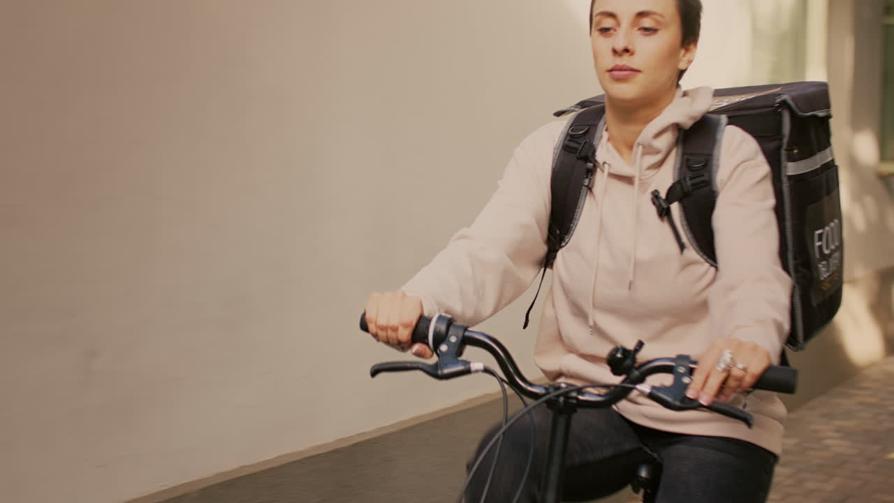 A woman on a bicycle doing food delivery