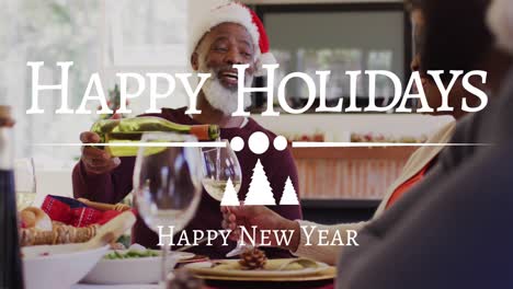 animation of happy holidays and new year text over african american man in santa hat pouring wine