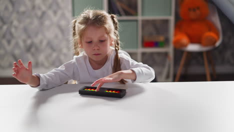 Bored-little-girl-with-plaits-turns-abacus-at-workplace