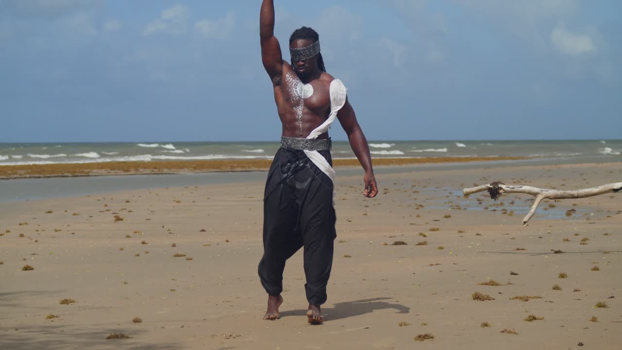 A muscular, dark-skinned man in Nekharis cosplay blends seamlessly with the tropical beach environment