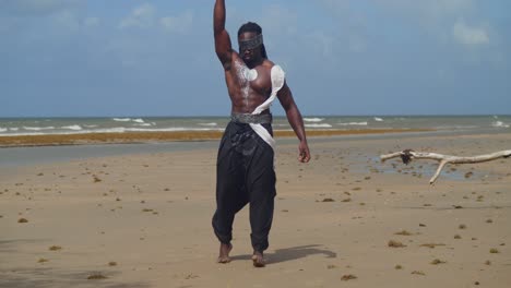 a muscular, dark-skinned man in nekharis cosplay blends seamlessly with the tropical beach environment