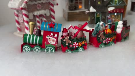 festive red christmas train with holiday-themed decorations in snowy setting