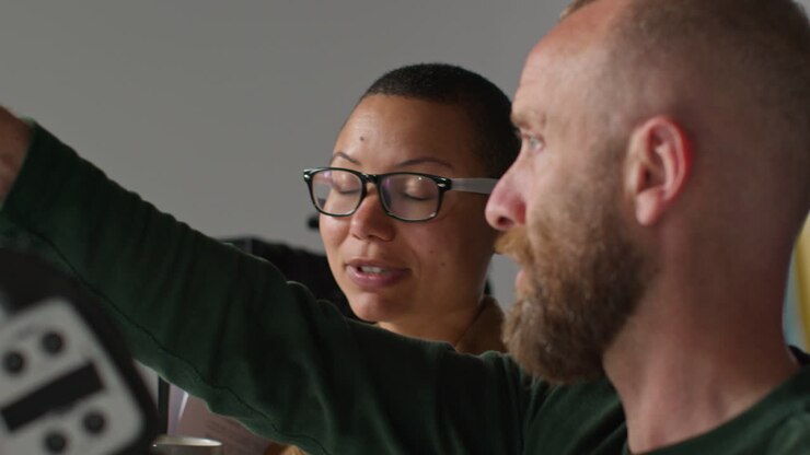 A woman and a man are talking in an office setting