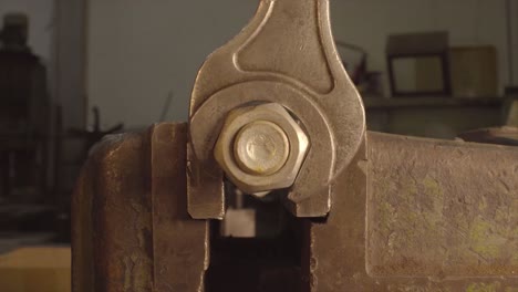 wrench tightening a nut in a vise