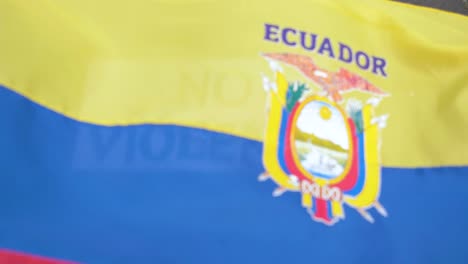 no violence in latin america, waving flag of ecuador over sign in english