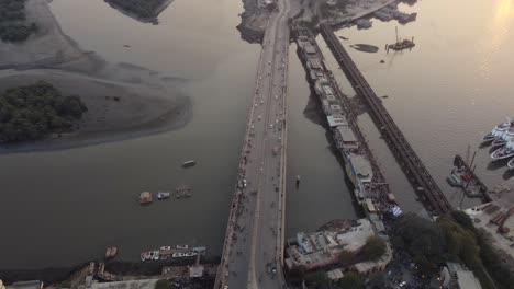 Aerial-Tilt-Up-Reveal-Of-Native-Jetty-Road-With-Karachi-Port-Terminal-In-Background-During-Sunset