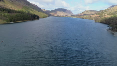 Aerial-Drone-Shot-Panning-Up-Revealing-Buttermere-Lake-and-Mellbreak-Hill-In-Background-in-Sunny-and-Cloudy-Conditions-Lake-District-Cumbria-United-Kingdom