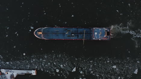 top view zoom out drone shot of a large fishing boat.