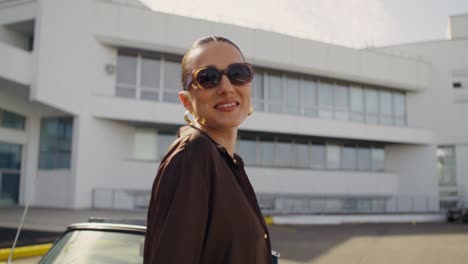stylish woman in front of modern building