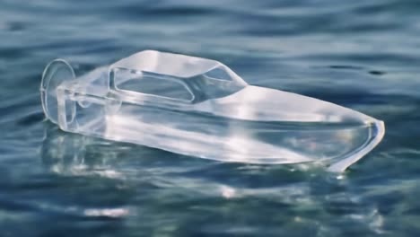 a stunning crystal boat floating gracefully on tranquil water, capturing the essence of serenity and clarity in a beautiful, reflective environment