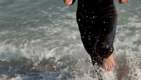 happy surfer running out of the sea