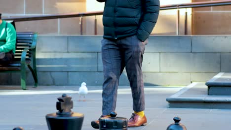 man walking near a chessboard in an urban setting