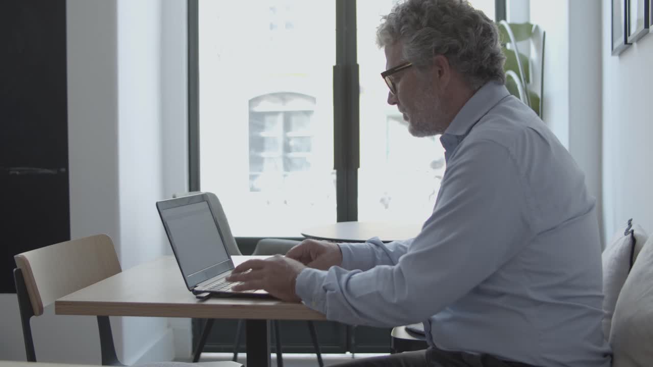 직장에 앉아 집중된 성숙한 사업가