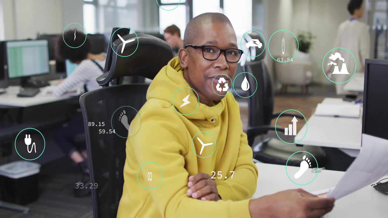 Animation of data processing and ecology icons over diverse colleagues working in office