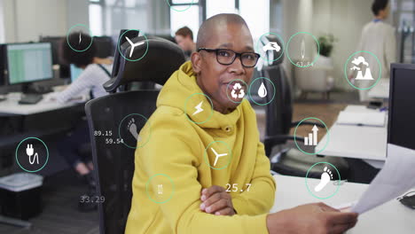 animation of data processing and ecology icons over diverse colleagues working in office