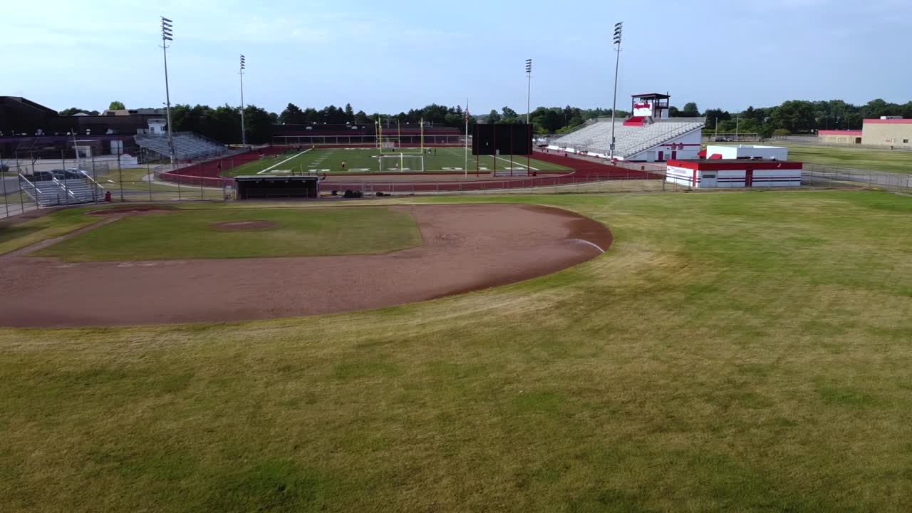 Drone footage of a suburban area and high school.
