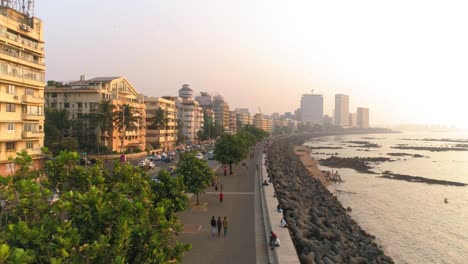 Drone-shots-of-the-most-iconic-walkway-of-South-Bombay,-Marine-Drive,-also-known-as-The-Queen's-Necklace-as-seen-before-The-Great-Mumbai-Coastal-Road-is-made