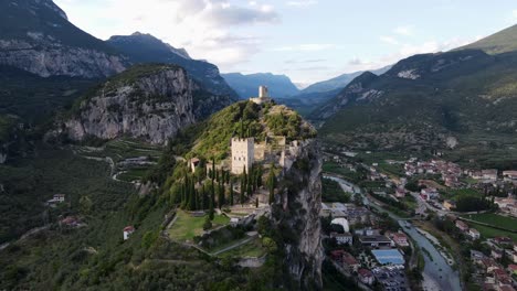 drone circle around castello di arco on the top of a steep mountain near lake garda, italy