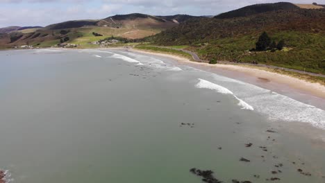 kaka point sandy beach aerial fly forward shot