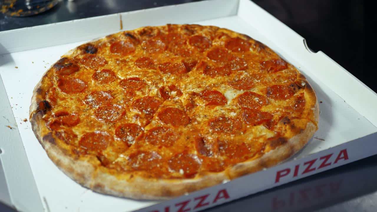 Delicious pepperoni pizza made from beef and pork seasoned with paprika and garlic powder spices ready for delivery, Closeup
