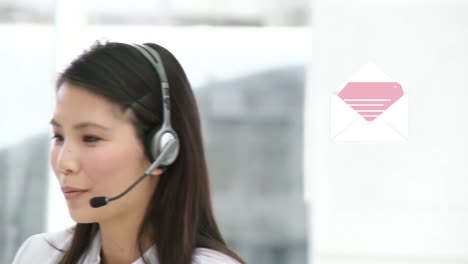 Animation-of-envelope-icon-over-asian-businesswoman-using-phone-headset