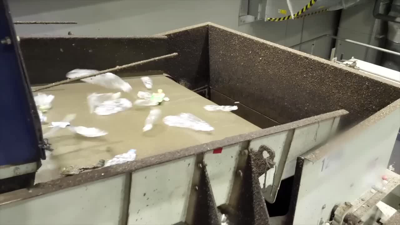 Conveyor with plastics and PET bottles. Plastic bottles destined for recycling - disposal and recovery of plastic waste due to environmental pollution.