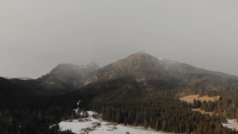 Slow-aerial-pan-to-the-right-over-a-village-and-forest-of-the-Val-Visdende-ravine-in-Italy