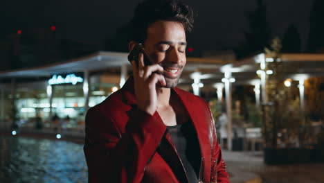 luxurious businessman ending call celebrating at night party on poolside.