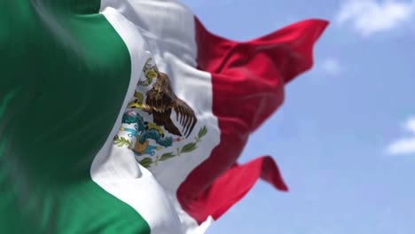 detailed close up of the national flag of mexico waving in the wind on a clear day