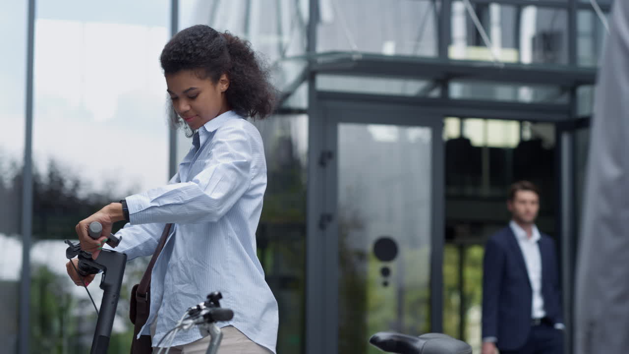 Smiling manager riding electric scooter after work. Corporate people lifestyle.