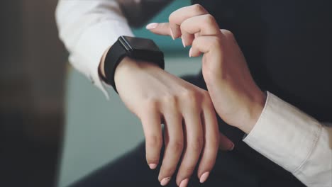 woman adjusting smartwatch on wrist