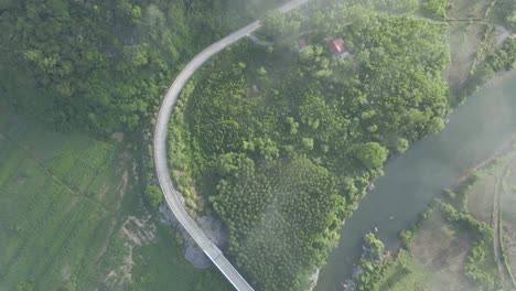 Drone-shot-high-above-a-road-with-some-cloud