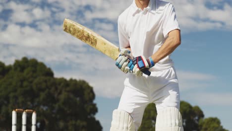 cricket player shooting in the ball in a pitch