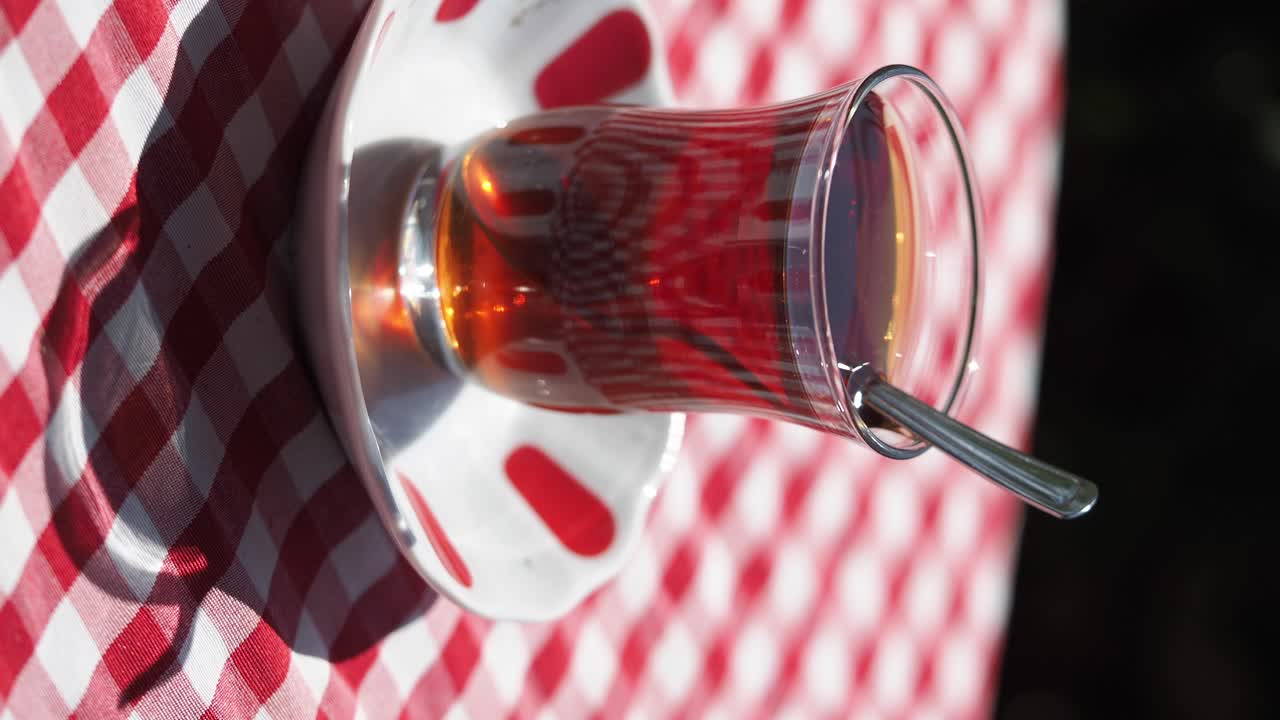A glass of Turkish tea with a spoon
