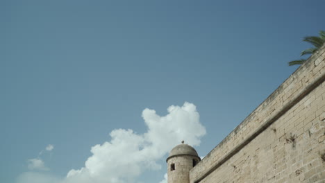 turret on surrounding walls of royal palace of la almudaina, palma de mallorca panning up on a sunny day