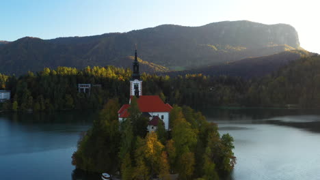 cinematic drone shot of the pilgrimage church of the assumption of mary, slovenia