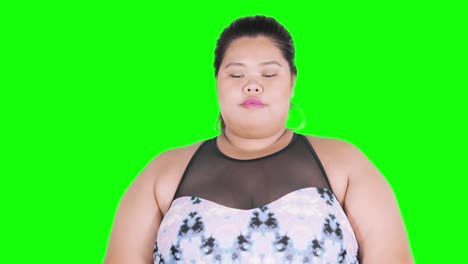 thoughtful overweight woman thinking in studio