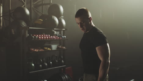 man working out with dumbbells in a gym
