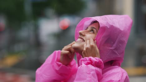 woman in a pink raincoat in the rain