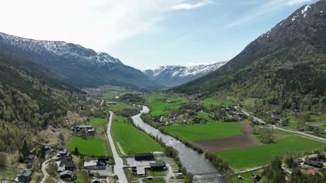 Road-RV55-leading-to-sognefjellet-mountain---Aerial-above-Bovra-river-seen-from-Fossbergom-Norway