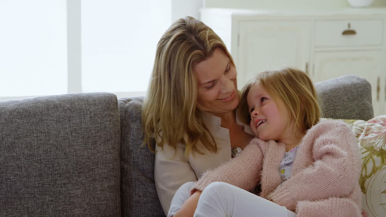 Mutter mit ihrer Tochter im Wohnzimmer 4k