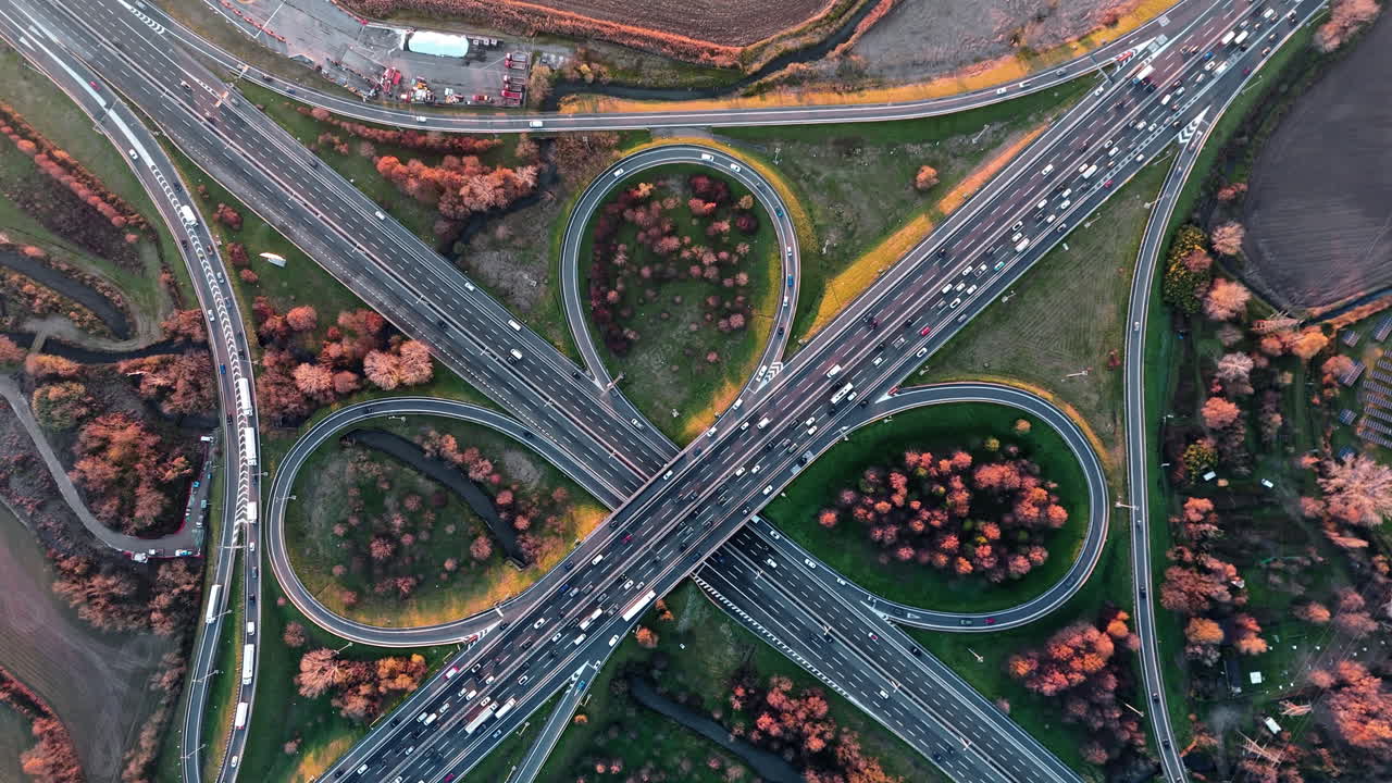 Aerial view of busy fall highway interchange with vibrant autumn colors